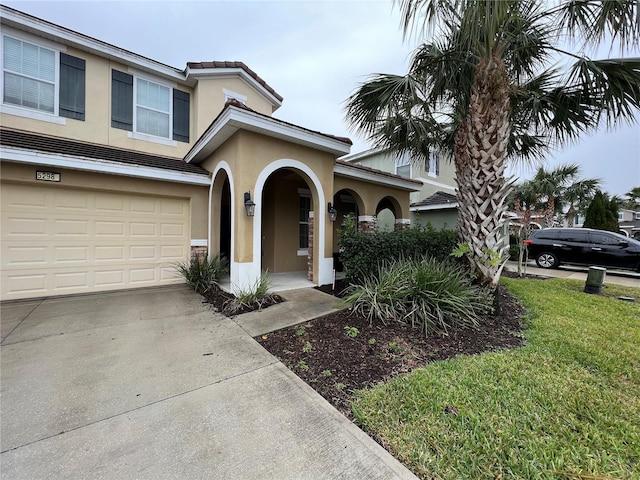 view of front of house with a garage and a front lawn