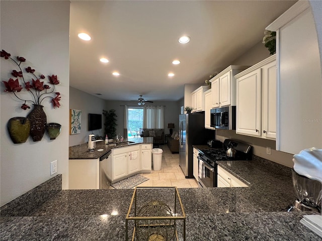 kitchen with sink, ceiling fan, appliances with stainless steel finishes, white cabinets, and kitchen peninsula