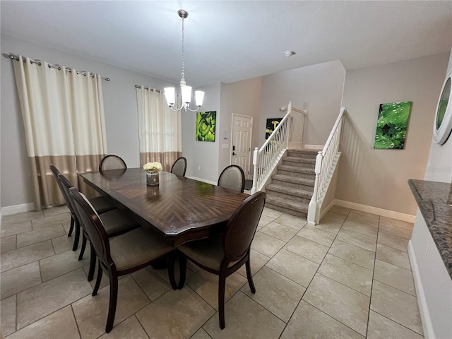 tiled dining space featuring a notable chandelier