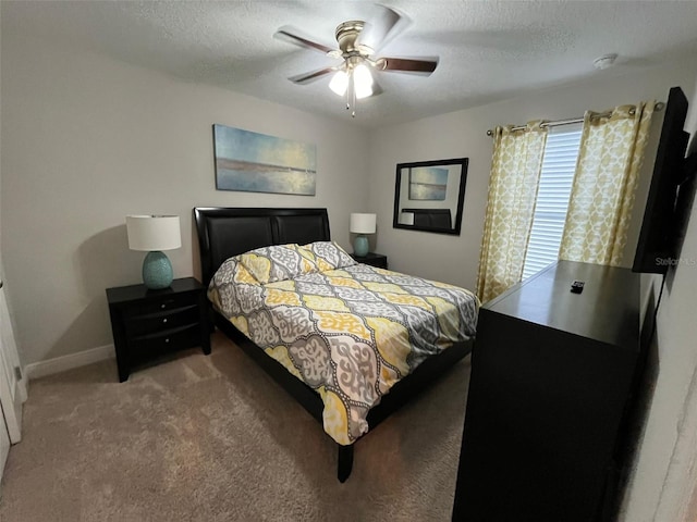 bedroom featuring ceiling fan, a textured ceiling, and carpet