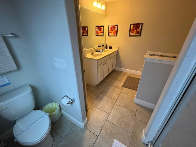 bathroom with vanity, tile patterned floors, and toilet