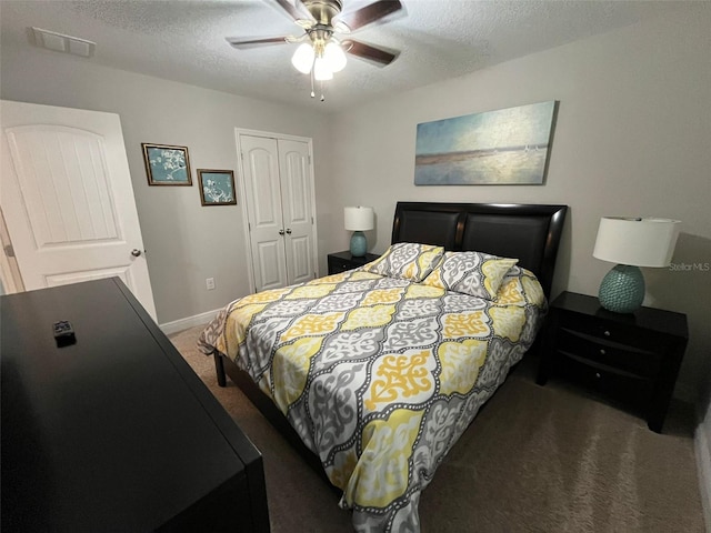 carpeted bedroom with ceiling fan, a closet, and a textured ceiling