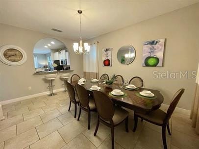 dining space featuring a notable chandelier