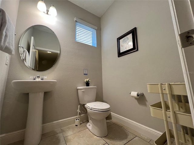 bathroom featuring tile patterned flooring and toilet