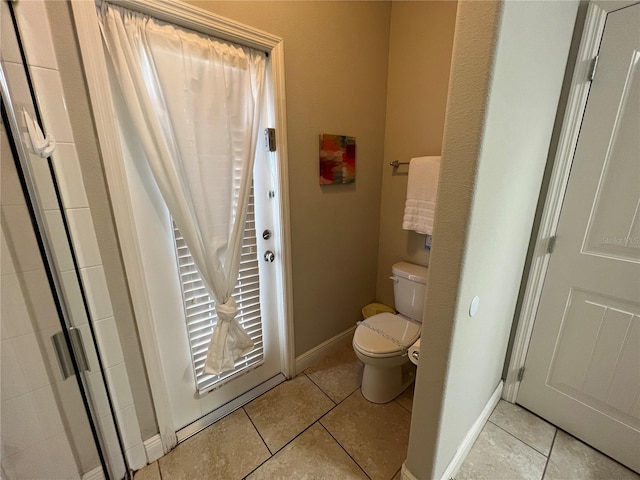 bathroom featuring tile patterned flooring and toilet