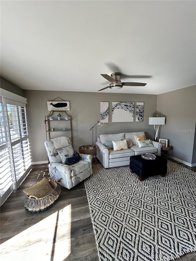 living room with wood-type flooring and ceiling fan