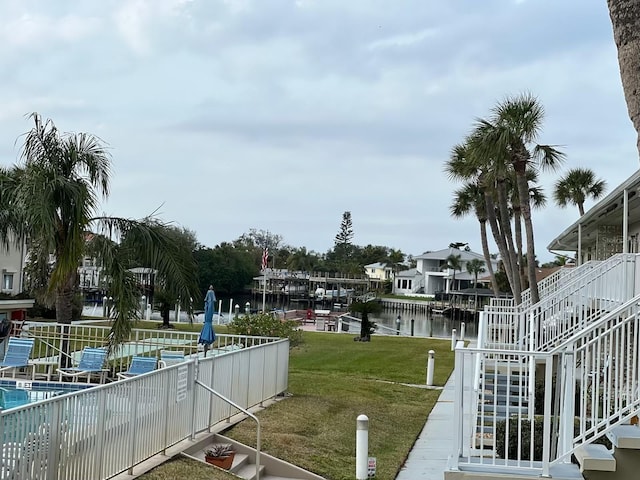 view of dock featuring a water view and a lawn