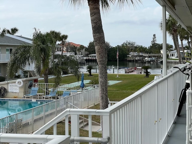 exterior space featuring a water view and a lawn