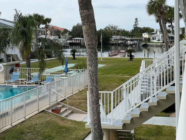 exterior space with a lawn and a water view