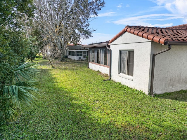 view of yard with a sunroom