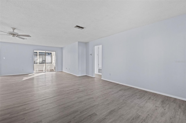 empty room with hardwood / wood-style floors, a textured ceiling, and ceiling fan