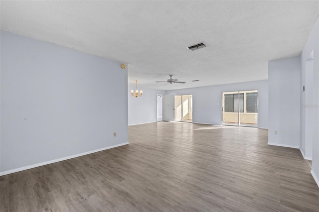 spare room with hardwood / wood-style floors, ceiling fan with notable chandelier, and a textured ceiling