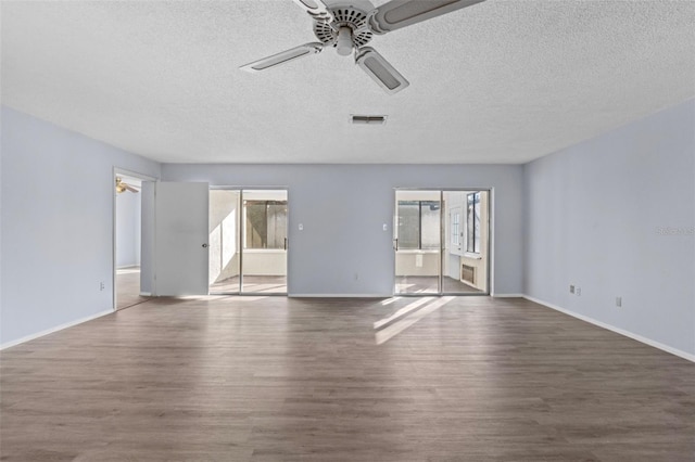 spare room with dark hardwood / wood-style floors, a textured ceiling, and ceiling fan