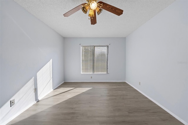 empty room featuring ceiling fan, hardwood / wood-style floors, and a textured ceiling