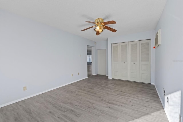 unfurnished bedroom with a textured ceiling, ceiling fan, and light hardwood / wood-style flooring