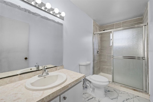 bathroom with vanity, toilet, and an enclosed shower