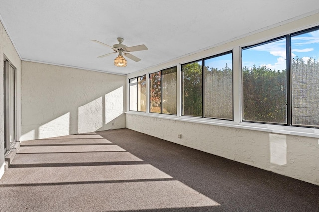 unfurnished sunroom with ceiling fan