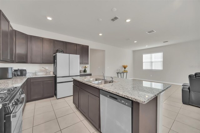 283 Archer Way, Haines City, FL 33844 - kitchen with sink, white refrigerator, gas stove, a center island with sink, and stainless steel dishwasher