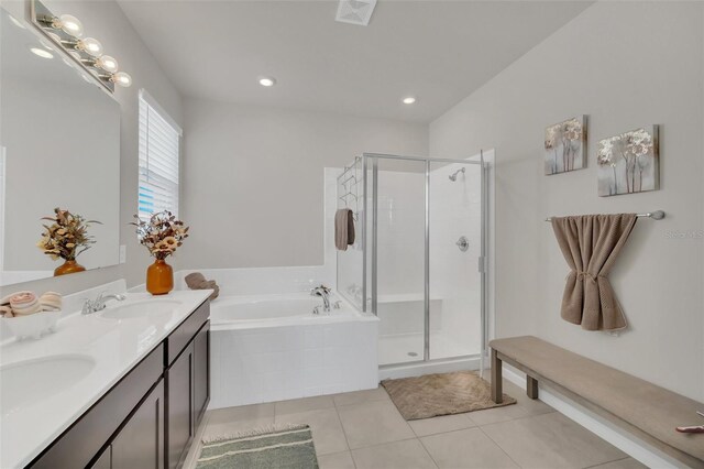 283 Archer Way, Haines City, FL 33844 - bathroom featuring tile patterned flooring, vanity, and shower with separate bathtub