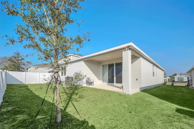 283 Archer Way, Haines City, FL 33844 - back of house with a lawn and a patio area