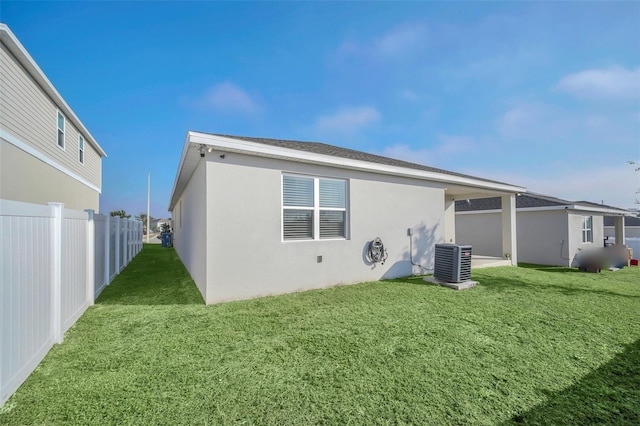 283 Archer Way, Haines City, FL 33844 - rear view of house featuring a yard and central air condition unit