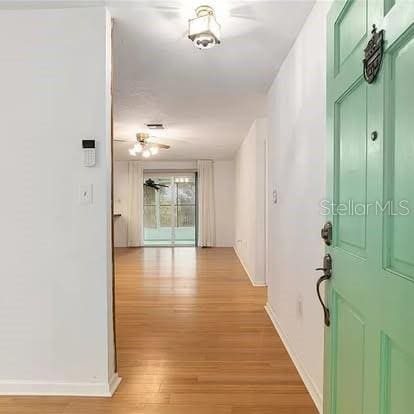 corridor with light wood-type flooring