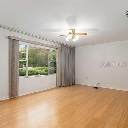 unfurnished room with ceiling fan and light hardwood / wood-style floors