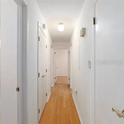 hallway with light hardwood / wood-style flooring