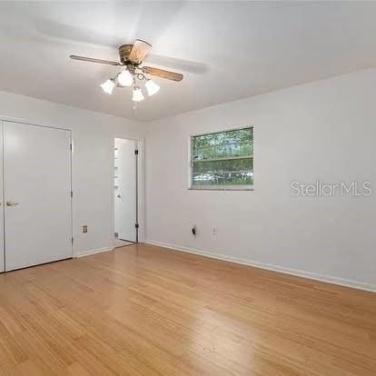 spare room with ceiling fan and light hardwood / wood-style floors