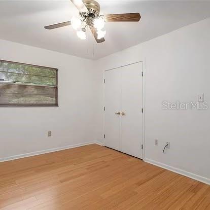 empty room featuring ceiling fan and light hardwood / wood-style flooring