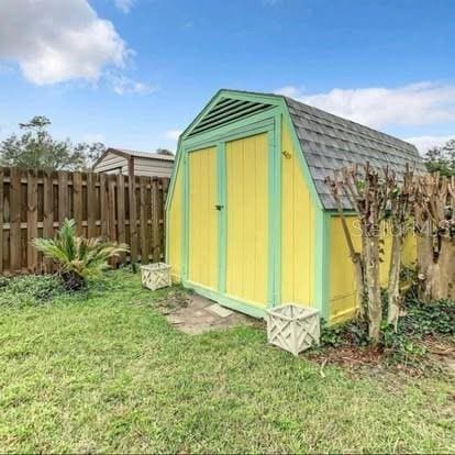 view of outbuilding with a yard