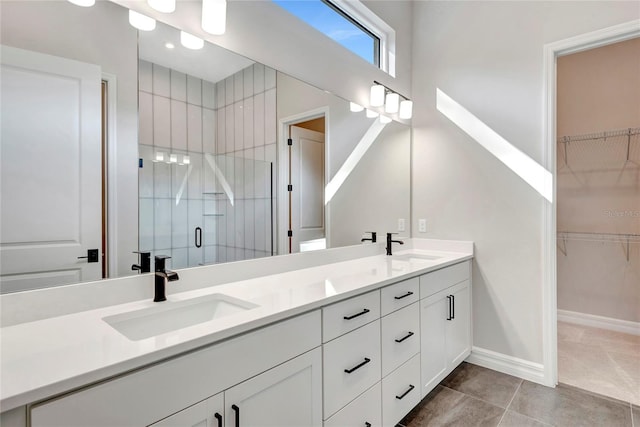 bathroom with tile patterned floors, vanity, and an enclosed shower