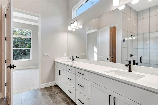 bathroom with tile patterned flooring, vanity, and a shower with shower door