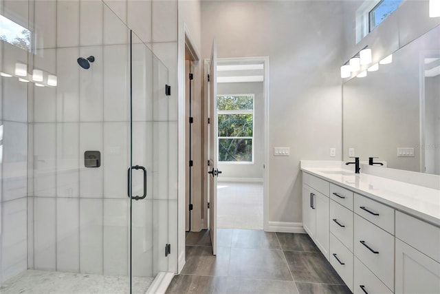 bathroom with vanity, tile patterned flooring, and a shower with door