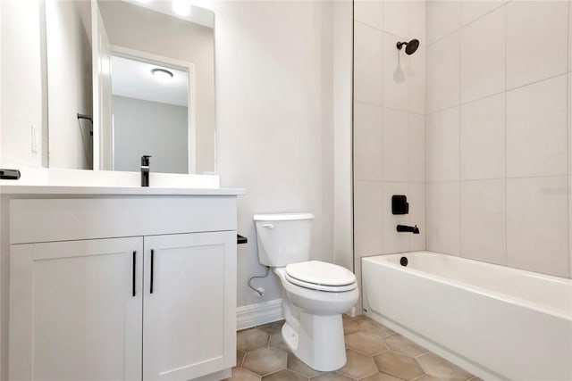 full bathroom with tiled shower / bath combo, vanity, tile patterned floors, and toilet