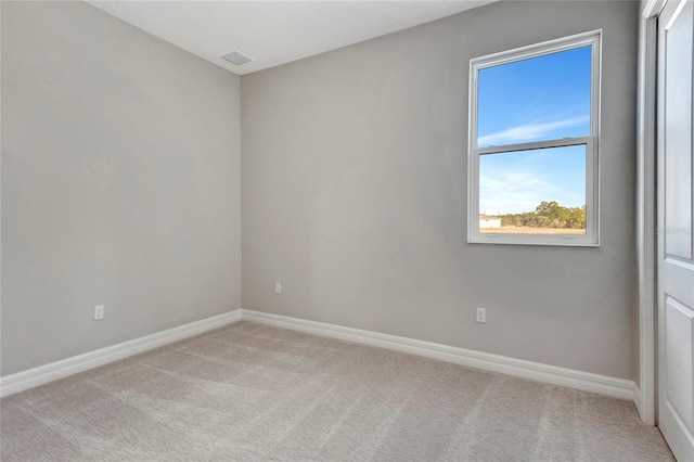 unfurnished room featuring light colored carpet