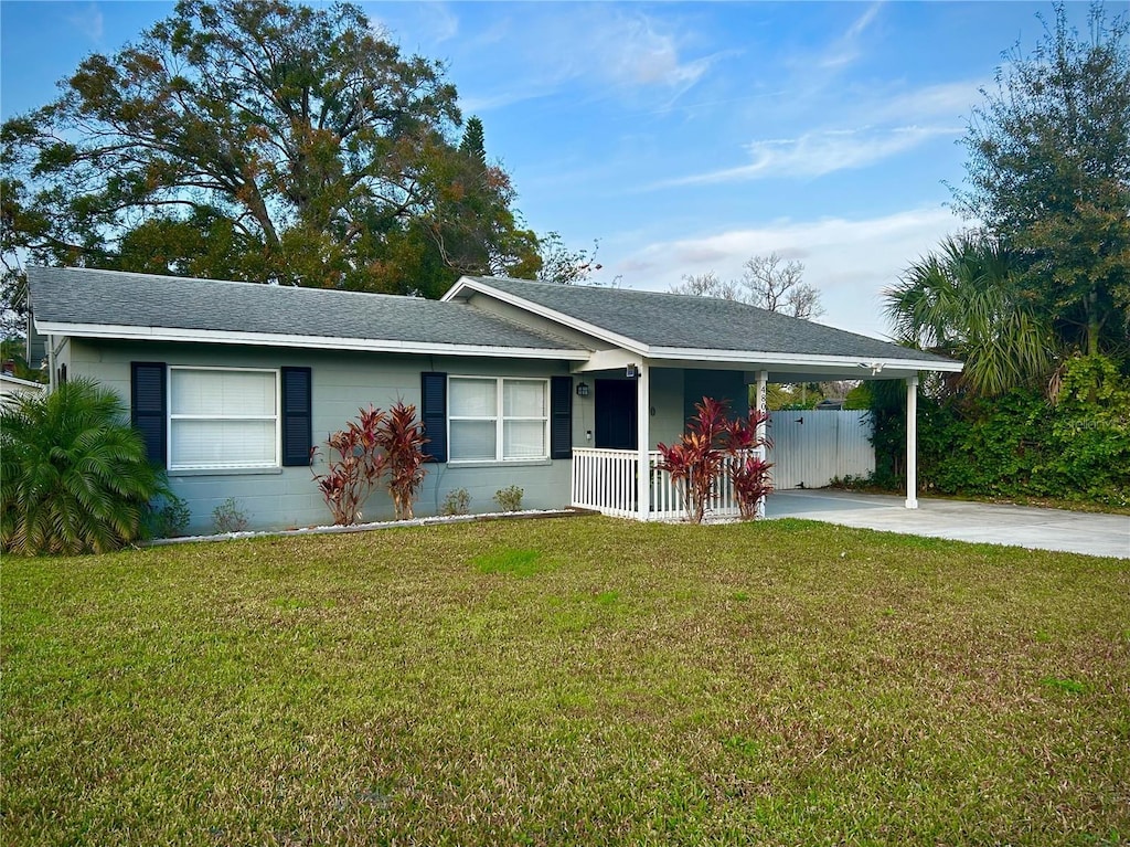 single story home featuring a carport and a front yard