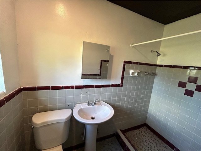 bathroom with tile walls and toilet