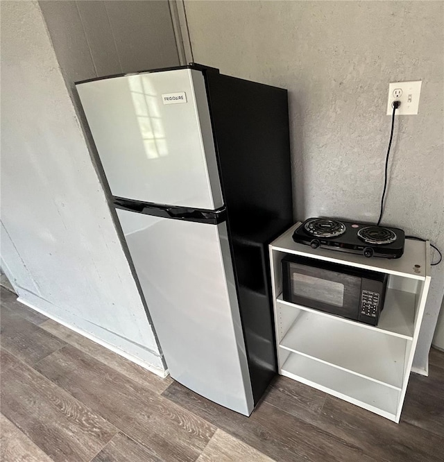 kitchen featuring dark hardwood / wood-style floors and refrigerator