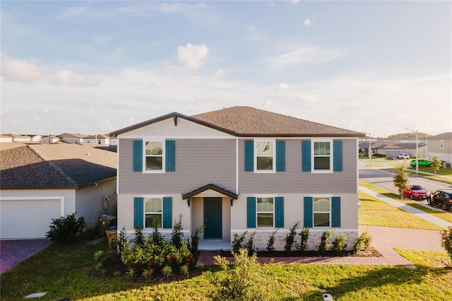 view of front of property featuring a garage and a front yard