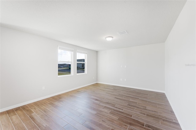 unfurnished room featuring wood-type flooring