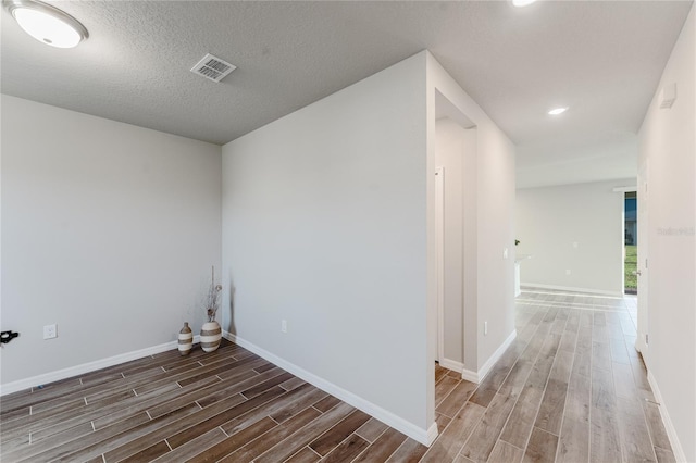 laundry area featuring dark hardwood / wood-style flooring and a textured ceiling