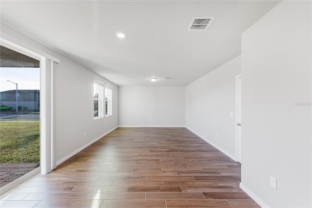 unfurnished room with hardwood / wood-style floors