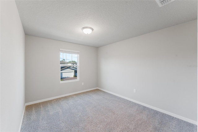 unfurnished room featuring carpet floors and a textured ceiling