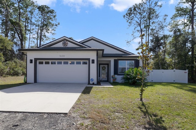 view of front of property with a garage and a front lawn