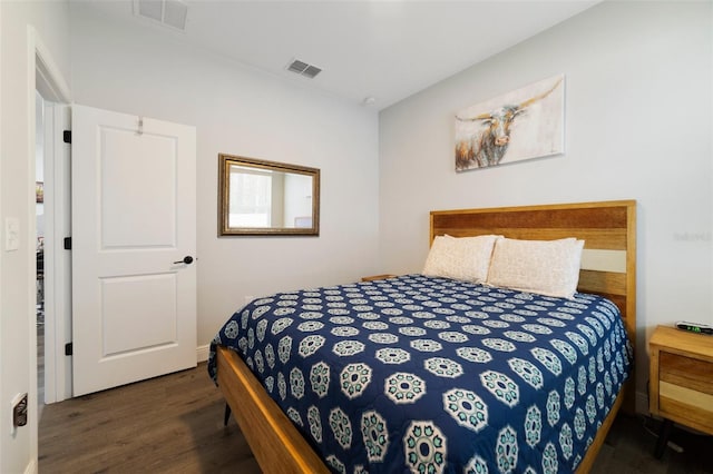 bedroom with dark hardwood / wood-style floors