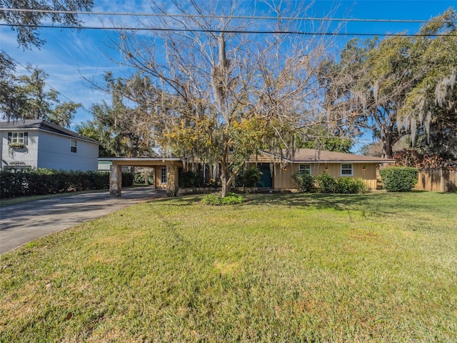 view of front of property with a carport and a front lawn