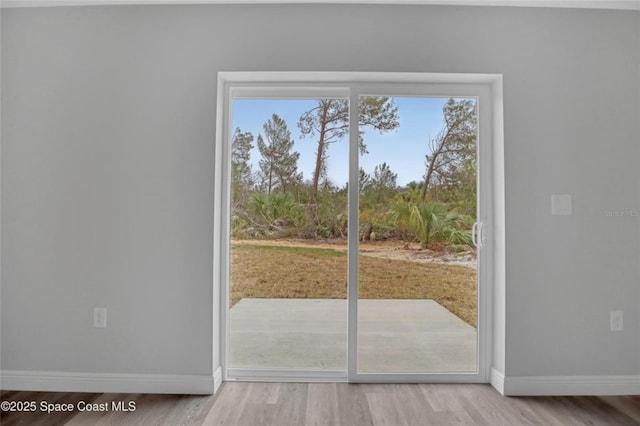 doorway with wood-type flooring