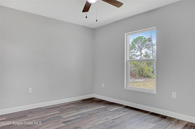 empty room featuring hardwood / wood-style flooring and ceiling fan