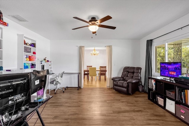 office space with dark hardwood / wood-style flooring and ceiling fan with notable chandelier